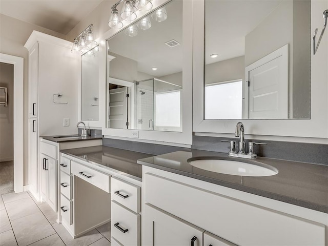 bathroom with visible vents, a shower stall, vanity, and tile patterned flooring