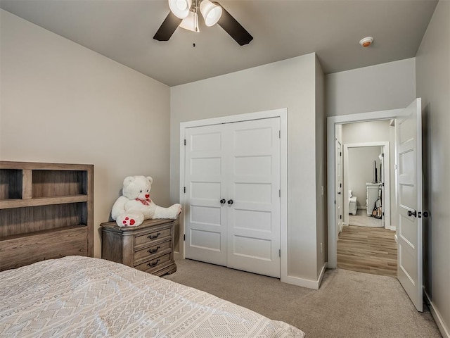 carpeted bedroom featuring baseboards and a ceiling fan