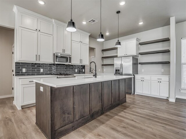 19001 Bobcat Ridge Ct, Cashion, OK 73016 - kitchen with open shelves, stainless steel appliances, a sink, light countertops, and recessed lighting