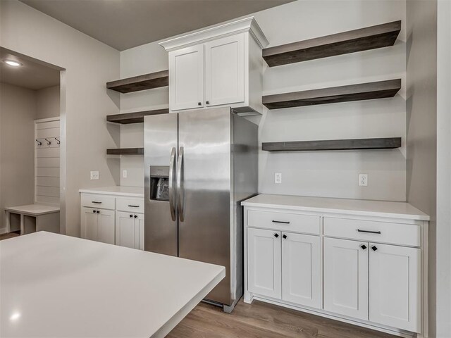 19001 Bobcat Ridge Ct, Cashion, OK 73016 - kitchen with open shelves, stainless steel fridge with ice dispenser, wood finished floors, white cabinets, and light countertops