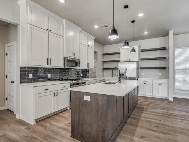 19001 Bobcat Ridge Ct, Cashion, OK 73016 - kitchen with open shelves, appliances with stainless steel finishes, a sink, light countertops, and recessed lighting