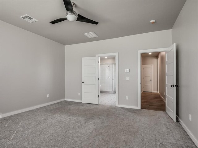 19001 Bobcat Ridge Ct, Cashion, OK 73016 - unfurnished bedroom with carpet, baseboards, connected bathroom, and a ceiling fan
