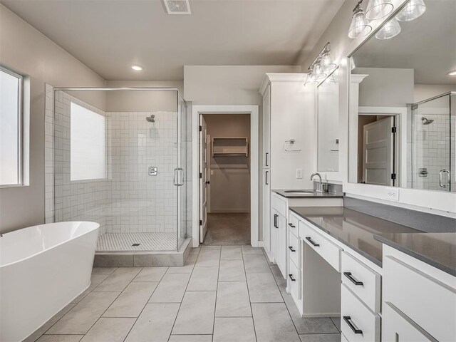 19001 Bobcat Ridge Ct, Cashion, OK 73016 - full bath featuring a stall shower, tile patterned flooring, vanity, a freestanding tub, and recessed lighting