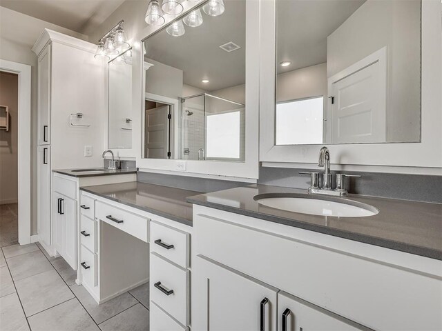 19001 Bobcat Ridge Ct, Cashion, OK 73016 - bathroom featuring tile patterned floors, a stall shower, and vanity