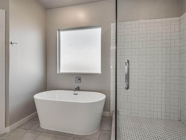 19001 Bobcat Ridge Ct, Cashion, OK 73016 - full bath featuring a soaking tub, tile patterned flooring, baseboards, and a tile shower
