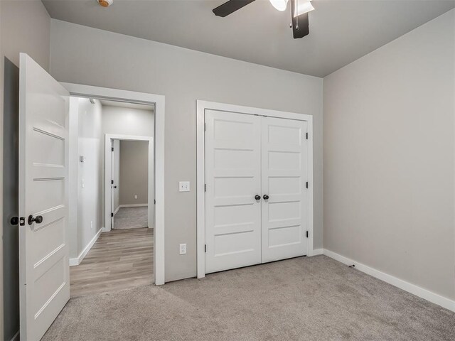 19001 Bobcat Ridge Ct, Cashion, OK 73016 - unfurnished bedroom featuring carpet floors, baseboards, a closet, and a ceiling fan