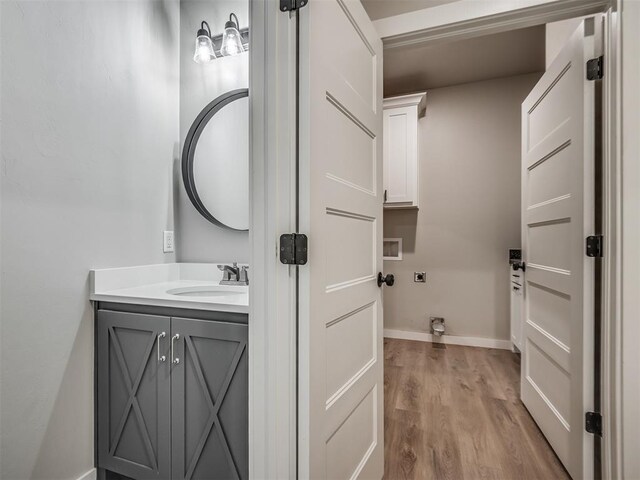 19001 Bobcat Ridge Ct, Cashion, OK 73016 - bathroom with vanity, wood finished floors, and baseboards
