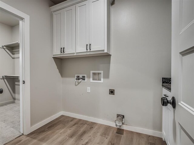 19001 Bobcat Ridge Ct, Cashion, OK 73016 - laundry room featuring hookup for an electric dryer, cabinet space, hookup for a washing machine, light wood-style flooring, and baseboards