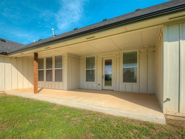 19001 Bobcat Ridge Ct, Cashion, OK 73016 - rear view of property with a patio, a yard, and roof with shingles