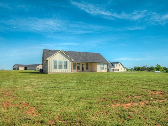 19001 Bobcat Ridge Ct, Cashion, OK 73016 - rear view of property featuring board and batten siding and a lawn
