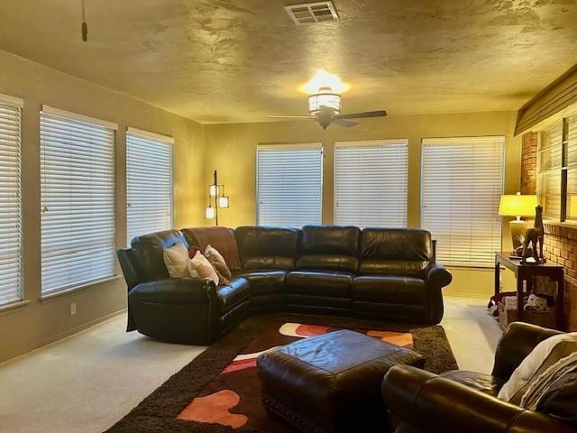 carpeted living room with ceiling fan