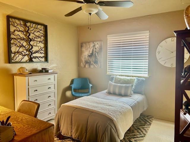 carpeted bedroom featuring ceiling fan