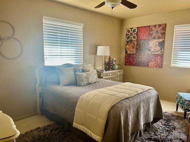 carpeted bedroom featuring ceiling fan