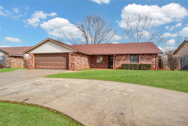 ranch-style house with a garage and a front lawn