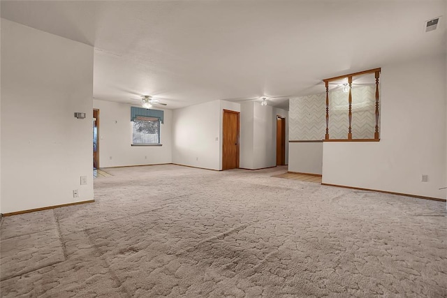 carpeted spare room with ceiling fan