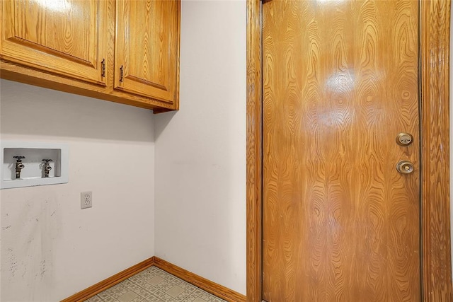 clothes washing area with hookup for a washing machine and cabinets