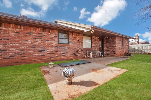 exterior space featuring a lawn and a patio area