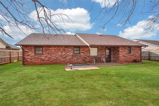 rear view of house featuring a lawn and a patio area