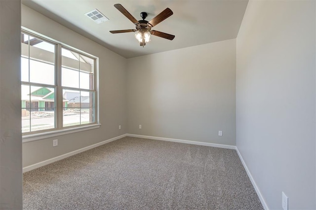 spare room featuring ceiling fan and carpet floors