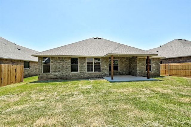 back of house with a patio area and a lawn