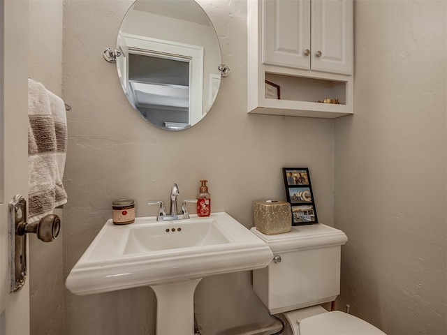 half bathroom with a sink and toilet