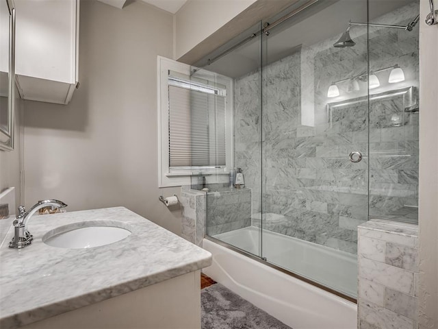 bathroom with shower / bath combination with glass door and vanity