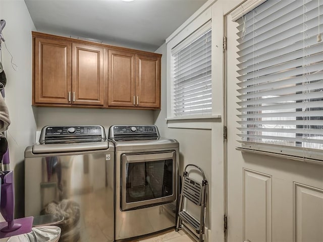 washroom featuring independent washer and dryer and cabinet space