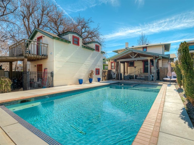 view of swimming pool featuring fence, a fenced in pool, and a patio