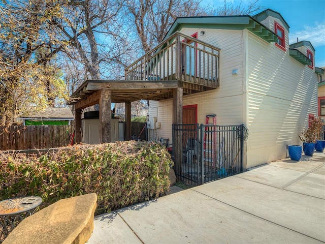 exterior space with fence, an outdoor structure, and a storage unit