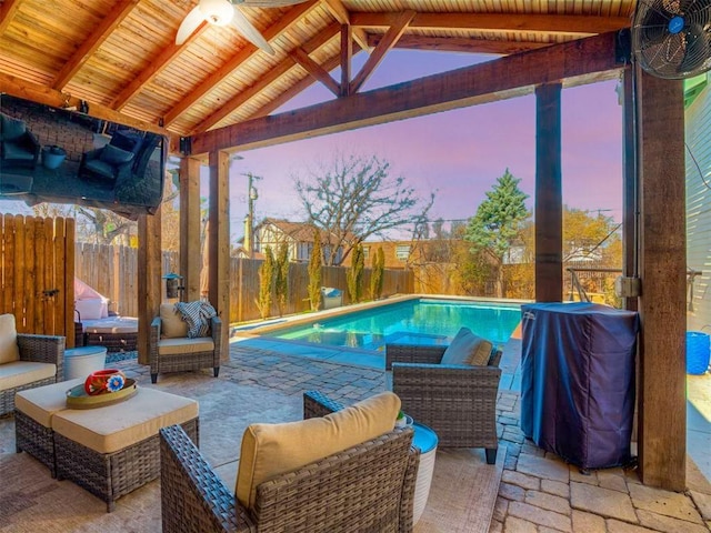 pool at dusk with a fenced in pool, a gazebo, area for grilling, a patio area, and a fenced backyard