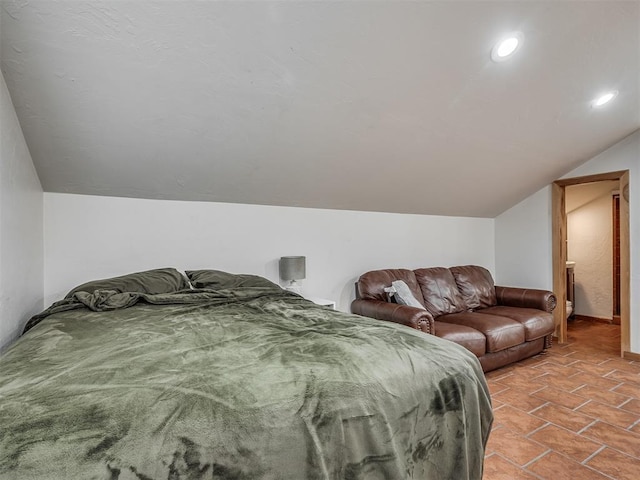 bedroom featuring vaulted ceiling, light tile patterned flooring, and recessed lighting