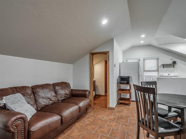 living room featuring vaulted ceiling and recessed lighting