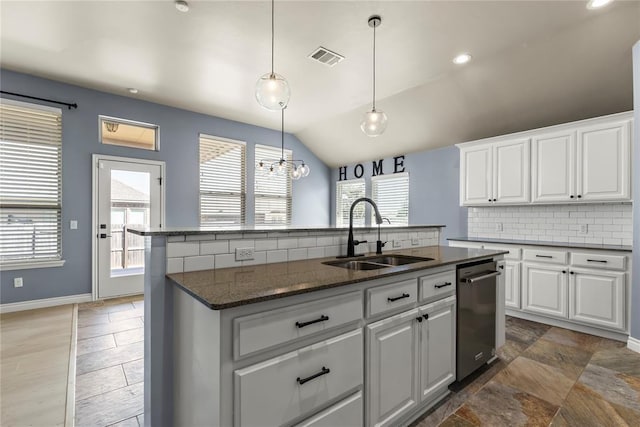 kitchen featuring decorative light fixtures, dishwasher, white cabinetry, sink, and a center island with sink