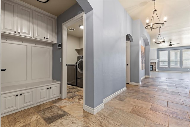 interior space featuring a chandelier and washer / dryer