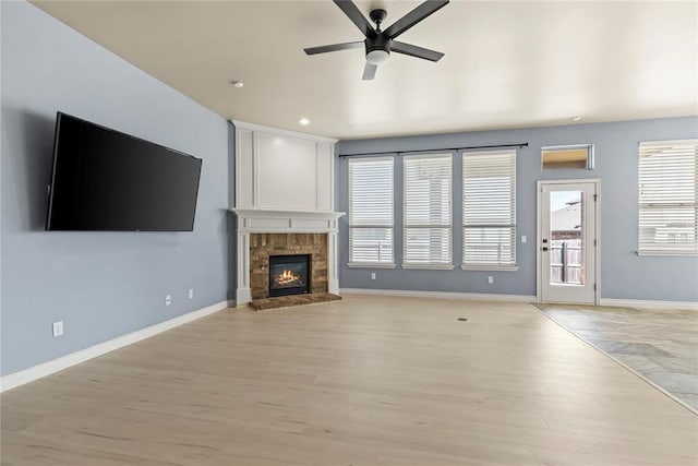 unfurnished living room with ceiling fan and light hardwood / wood-style floors