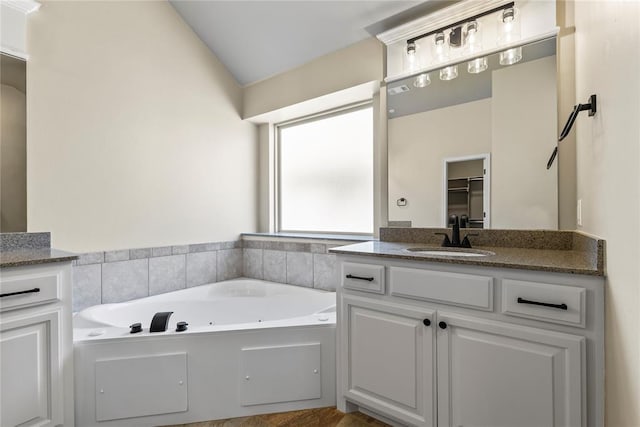 bathroom with vanity and a bathtub