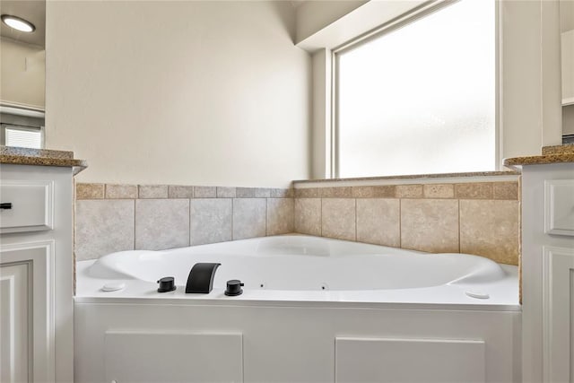 bathroom featuring vanity and a tub