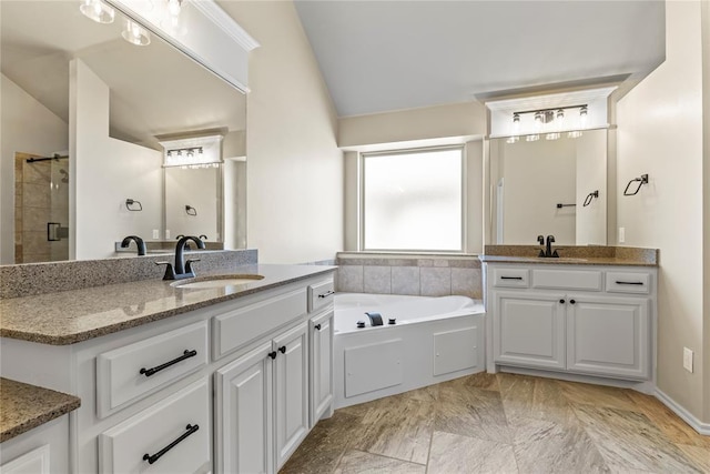 bathroom with independent shower and bath, vanity, and lofted ceiling