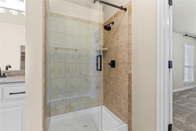 bathroom featuring vanity and a shower with shower door