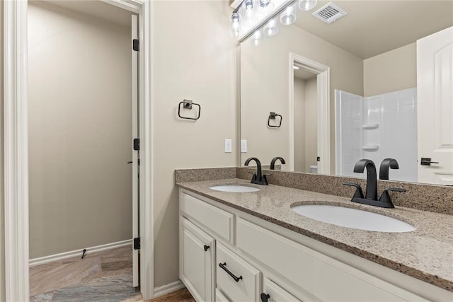 bathroom featuring vanity and walk in shower