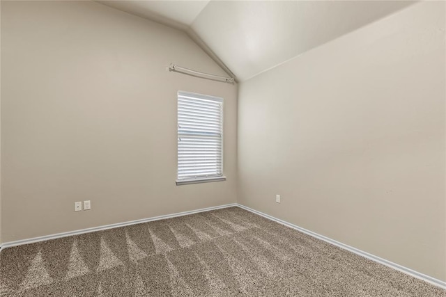 carpeted empty room with lofted ceiling