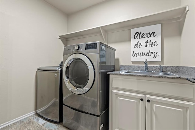 laundry room with cabinets, separate washer and dryer, and sink