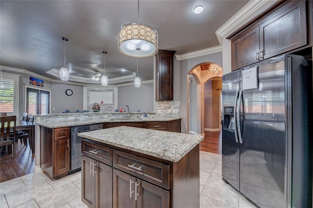 kitchen with a kitchen island, hanging light fixtures, stainless steel dishwasher, kitchen peninsula, and black refrigerator with ice dispenser