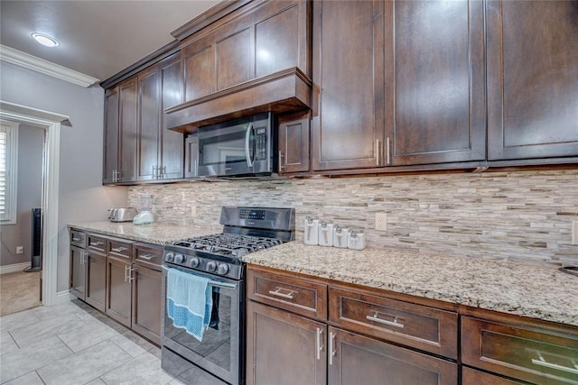 kitchen featuring light stone countertops, backsplash, ornamental molding, and stainless steel appliances