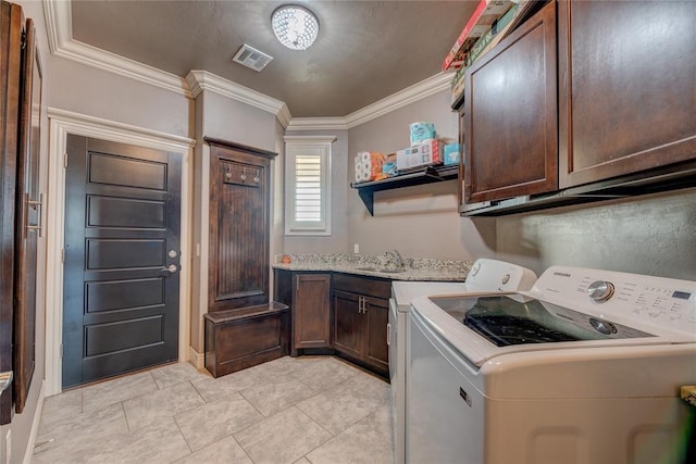 clothes washing area featuring light tile patterned flooring, sink, cabinets, ornamental molding, and washing machine and clothes dryer