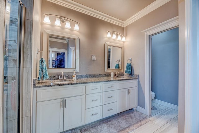 bathroom featuring ornamental molding, toilet, and vanity