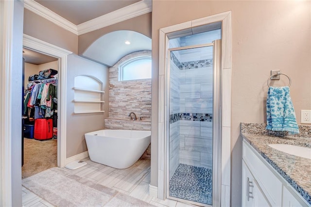 bathroom featuring vanity, crown molding, and separate shower and tub