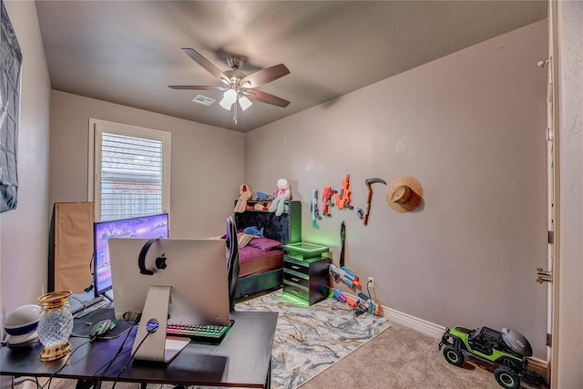 carpeted office space featuring ceiling fan