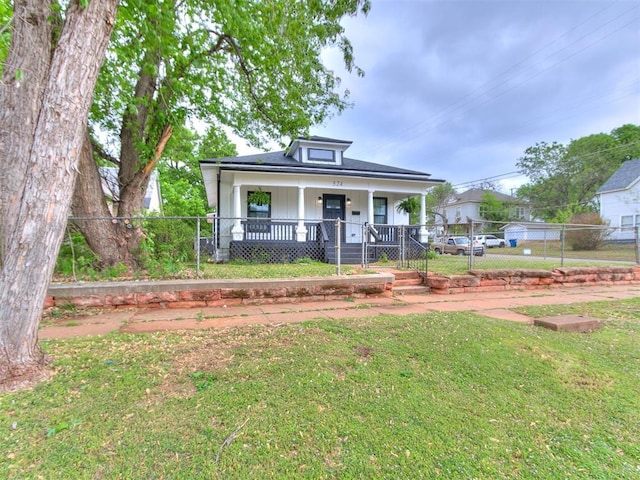 bungalow with a porch and a front yard