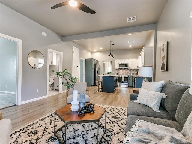 living room featuring light hardwood / wood-style floors and ceiling fan